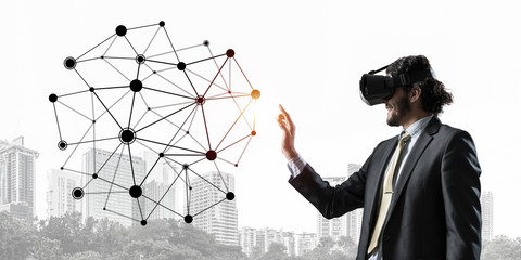 Handsome businessman experiencing impressive virtual reality connection concept