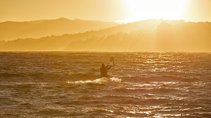 Kite surfer in a sunset light