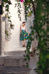Tourist Girl on Beautiful Streets of old Marmaris. Narrow streets with stairs among the houses with white brick, green plants and flowers in the old town of resort of in Turkey