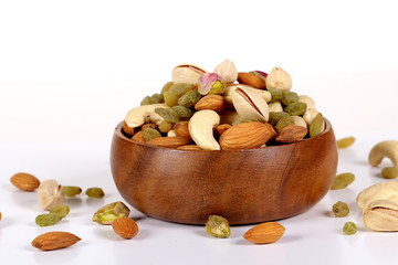 ssorted nuts on white, dry fruits, mix nuts, almond, cashew, pistachio, raisin