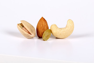 ssorted nuts on white, dry fruits, mix nuts, almond, cashew, pistachio, raisin