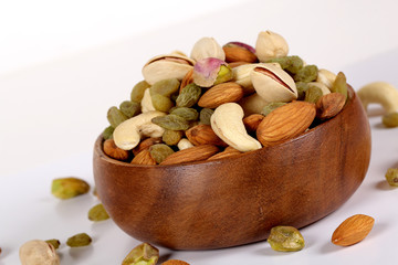 ssorted nuts on white, dry fruits, mix nuts, almond, cashew, pistachio, raisin