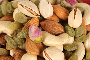 ssorted nuts on white, dry fruits, mix nuts, almond, cashew, pistachio, raisin