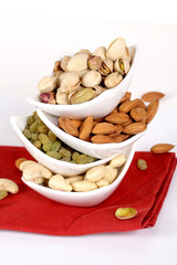 ssorted nuts on white, dry fruits, mix nuts, almond, cashew, pistachio, raisin