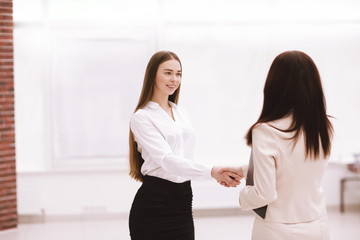 successful business woman shaking hands with employee