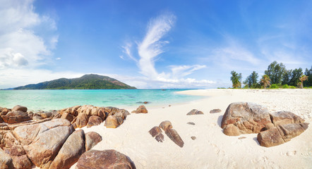 Empty sunny Koh Lipe Bulow Beach with rocks on foreground