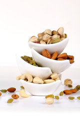 ssorted nuts on white, dry fruits, mix nuts, almond, cashew, pistachio, raisin