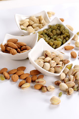 ssorted nuts on white, dry fruits, mix nuts, almond, cashew, pistachio, raisin