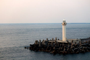Lighthouse at the harbor at sunset