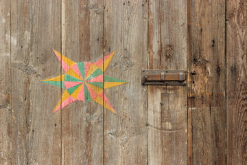 decorative symbol on the old wooden door
