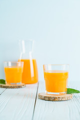 Fresh orange juice on wood background
