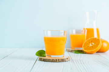 Fresh orange juice on wood background