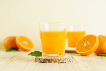 Fresh orange juice on wood background
