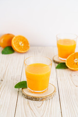 Fresh orange juice on wood background