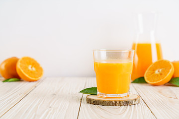 Fresh orange juice on wood background