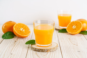 Fresh orange juice on wood background