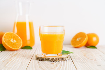 Fresh orange juice on wood background