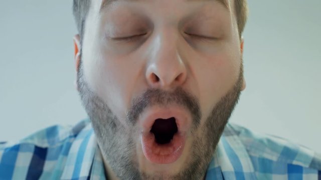 shocked or surprised male with wide open mouth, close up, concept human emotion