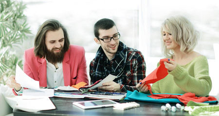 designers discussing new fabric patterns in the Studio.
