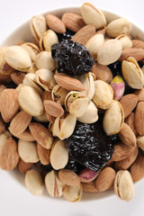 Assorted nuts on white, dry fruits, mix nuts, roasted almond, prunes, pistachio