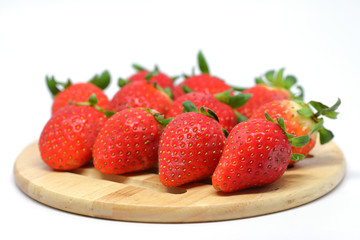 red strawberry on wooden plate