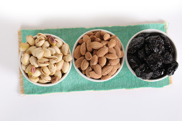 Fototapeta na wymiar Assorted nuts on white, dry fruits, mix nuts, roasted almond, prunes, pistachio