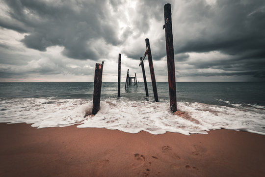 A ruined bridge on the ocean shore near the Aleenta Holiday Resort, Phuket, Thailand
