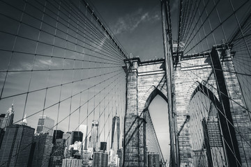 The Brooklyn Bridge in black and white with the new World Trade Center in the background, New York...