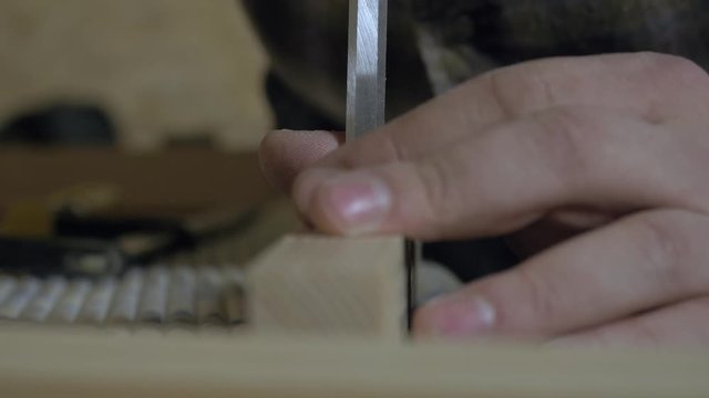 Carpenter hands using tool to work with wood Board