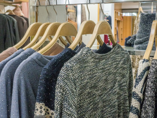 Fototapeta premium Sweaters on a rack in fashion store