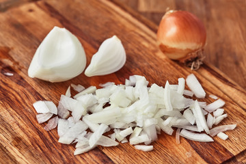 Sliced onion is on a wooden table. Close-up