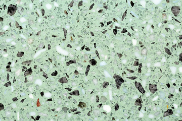 Close up of terrazzo flooring background texture with green base and marble and stone chips