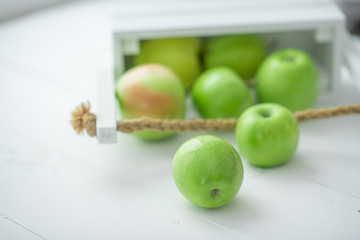 fresh green apples in a box on white background