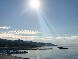 Naklejka na ściany i meble Sun rays on the city of Sanremo early morning