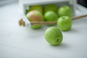 fresh green apples in a box on white background