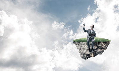 Young businessman or student floating in sky and studying the science