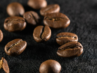 Focus on a single coffee bean on a background of many grains of coffee