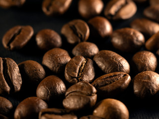 Focus on a single coffee bean on a background of many grains of coffee