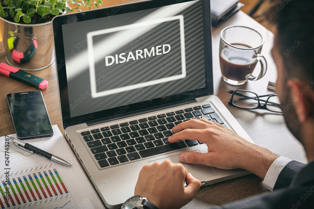 Poster man working with a computer, disarmed text on the screen, office background