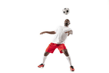 Fototapeta na wymiar Professional african american football soccer player in motion isolated on white studio background. Fit jumping man in action, jump, movement at game.