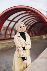Fototapeta premium Street fashionable close up portrait of young hipster girl in yellow suit and black hat outdoors