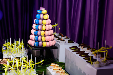 Pyramid of French macaroons on the candy bar