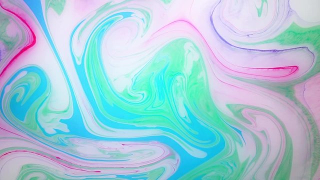 Stains of colored ink on the water. Colorful spots in motion. Abstract background footage.