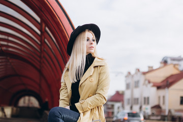 Obraz premium Street fashionable close up portrait of young hipster girl in yellow suit and black hat outdoors