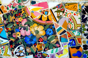 Fototapeta na wymiar Mosaici colorati di Gaudì con fiori, Park Guell, Barcellona, Spagna