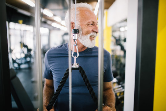 Senior man at the gym doing exercise to stay healthy