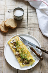 Vegetarian breakfast, omelette with mushrooms and cress, served with rye bread and coffee with milk. Rustic style.