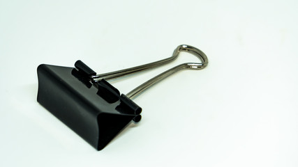 Black paper clip on a white background