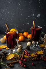 milled Hot wine with Christmas decorations background. Holiday dark photo.
