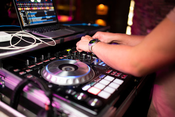 Fototapeta na wymiar DJ plays music in the club